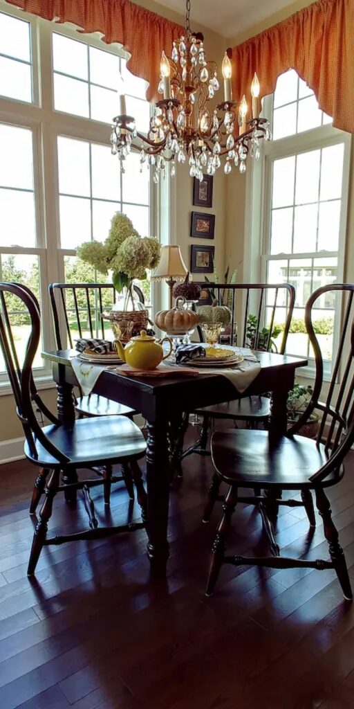 view of breakfast room table with chandelier and table set with pumpkins and sunflower dishes