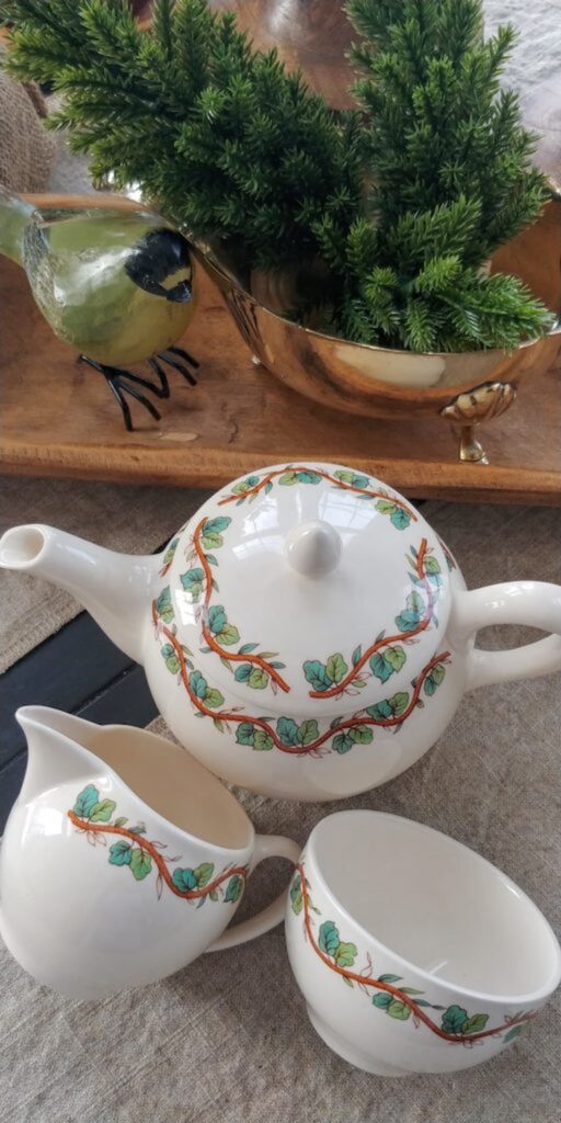 ivory tea pot with green vines on top from tiffany and company