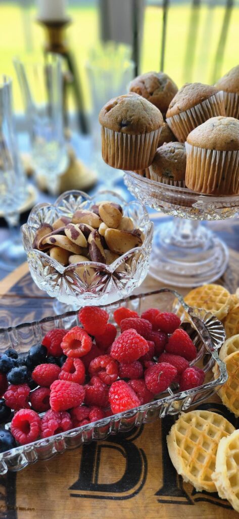 vintage crystal dish with brazil nuts and another dish with raspberries and blueberries
