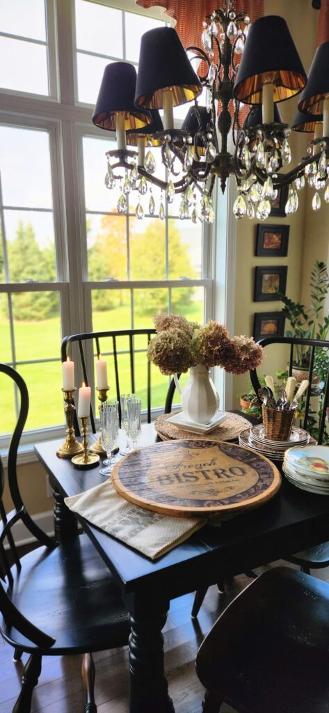 breakfast room table near window with a large wooden lazy susan charcuterie board on table