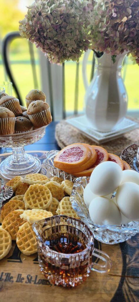 hard boiled eggs, mini waffles and syrup on breakfast charcuterie board