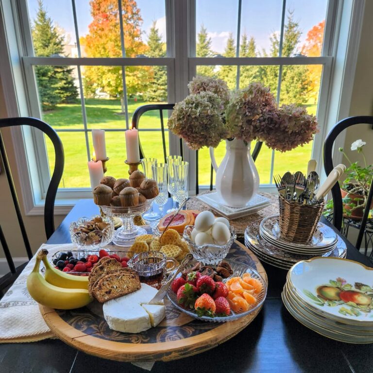 kitchen table with a breakfast charcuterie board filled with breakfast options to eat
