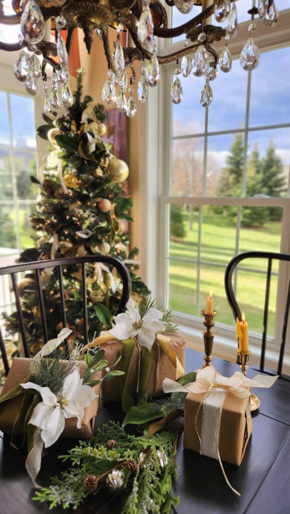 christmas tree with brown paper packages tied with string on table in front of tree