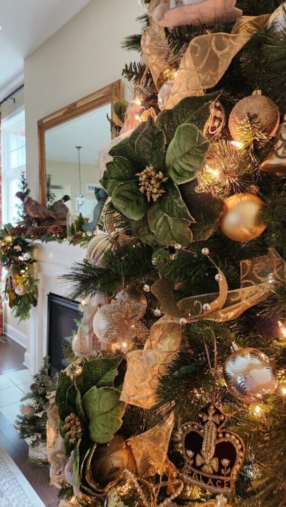 close up of gold and green ornaments on christmas tree with view of mantel in the backgroud
