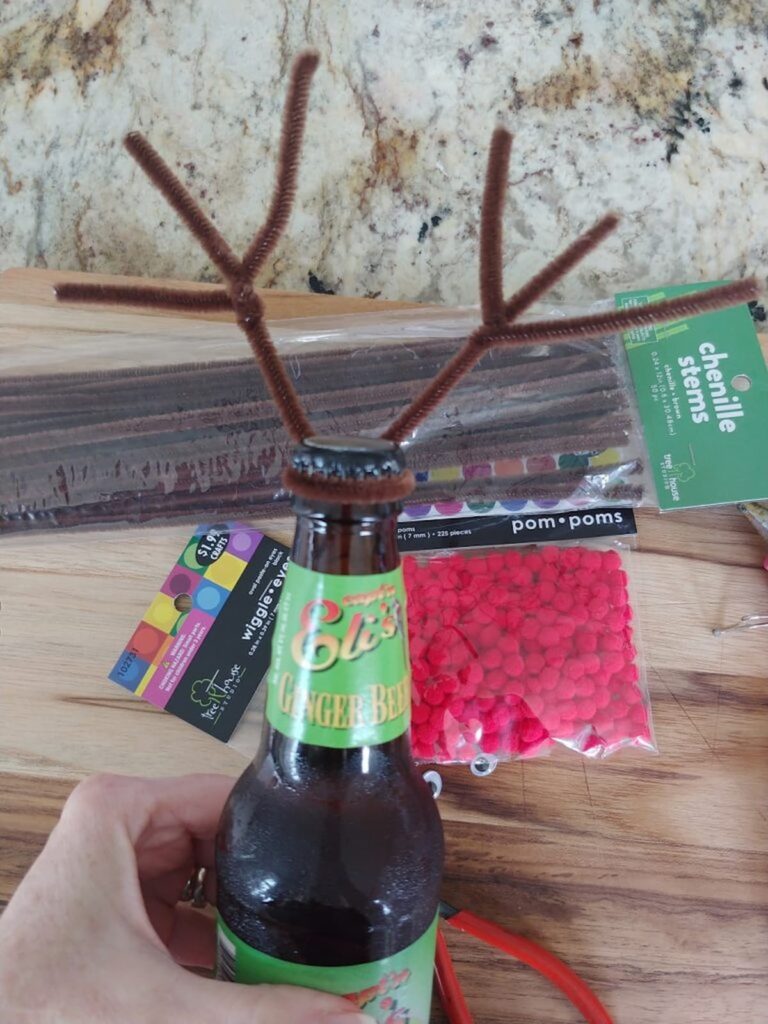 two smaller pipe cleaners wrapped around larger pipe cleaner to make deer antlers for bottle diy