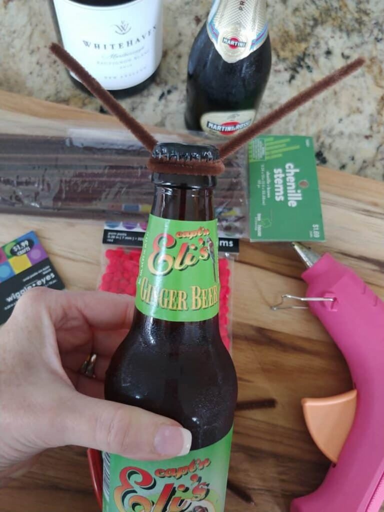 brown pipe cleaner wrapped around the top of the bottle for reindeer antlers