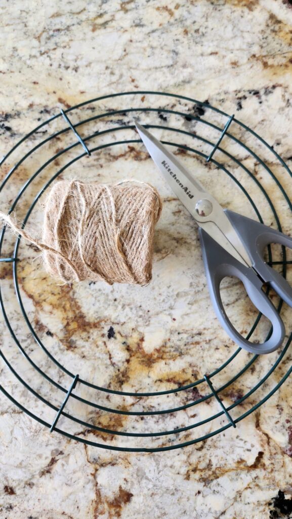 wire wreath form with jute twine and a pair of scissors