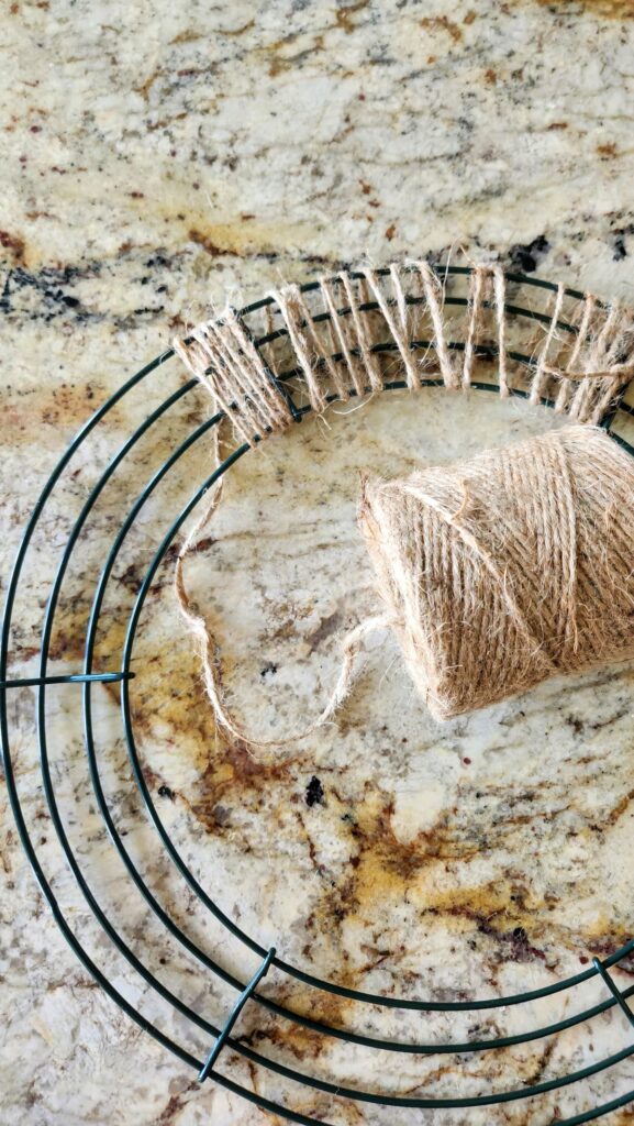 jute twine being wrapped around the wire wreath form