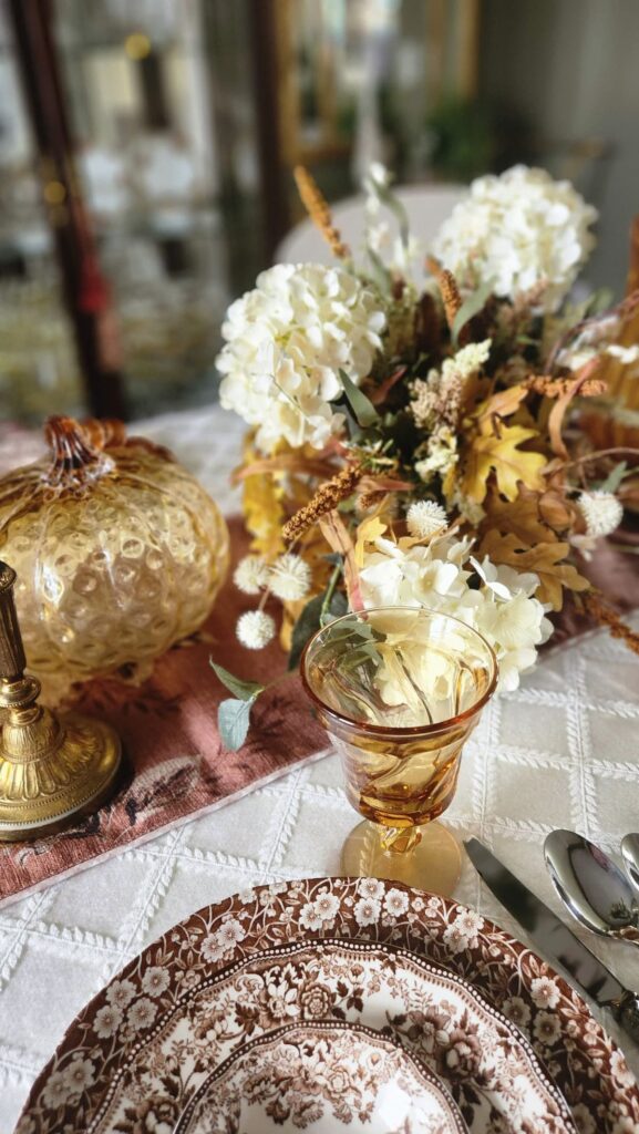 amber pumpkin and amber stemware on table for thanksgiving