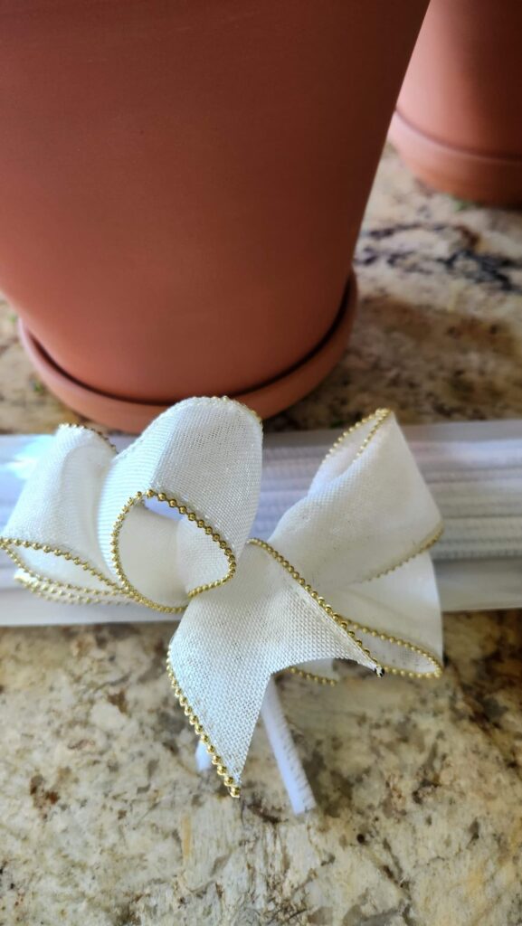 ivory bow for the top of the pine cone topiary