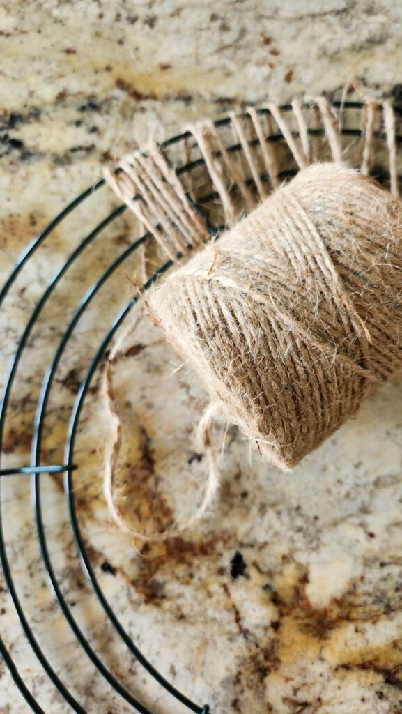 jute twine being added to wire wreath frame