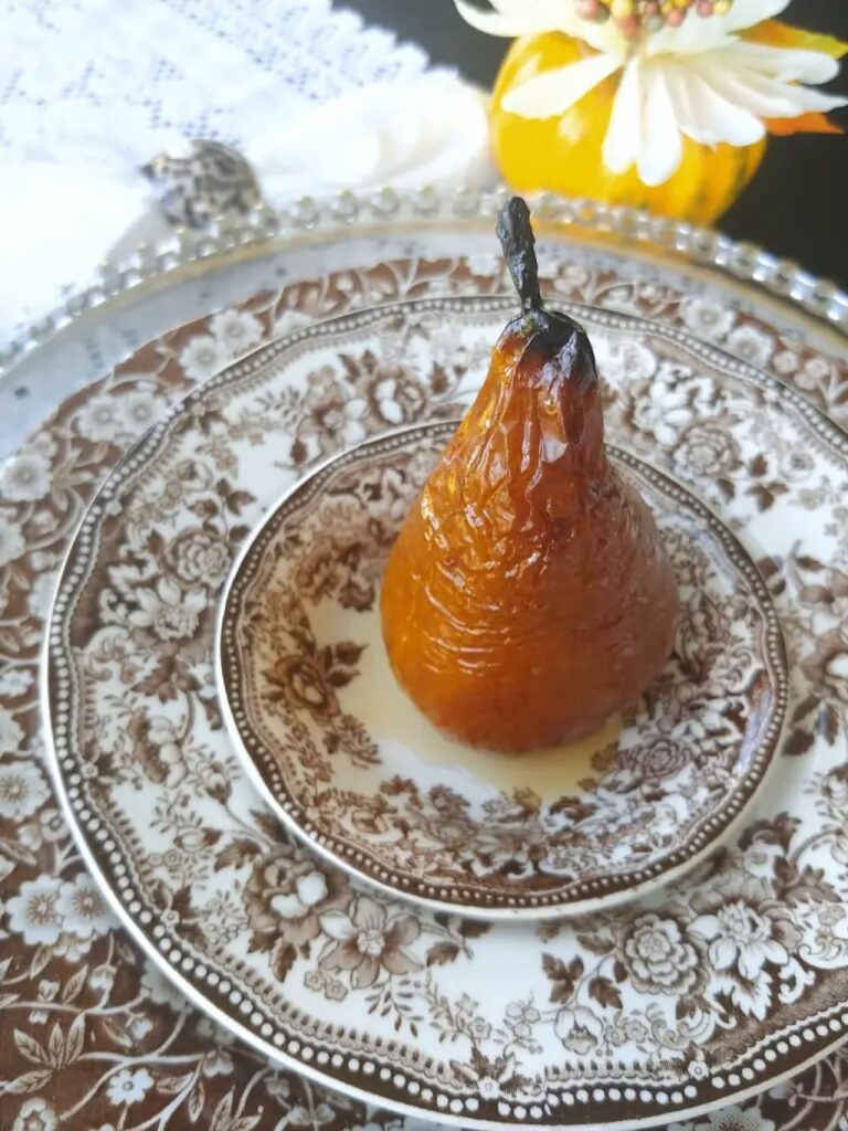 single baked pear on vintage brown transferware plate