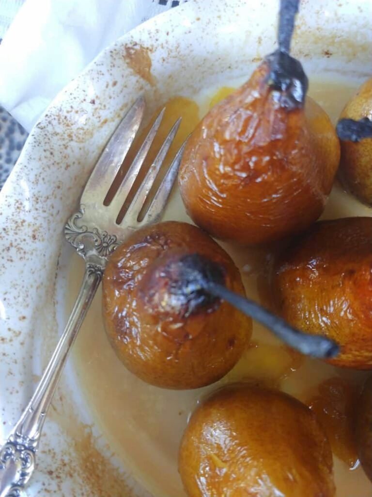 baked pears in a white baking dish
