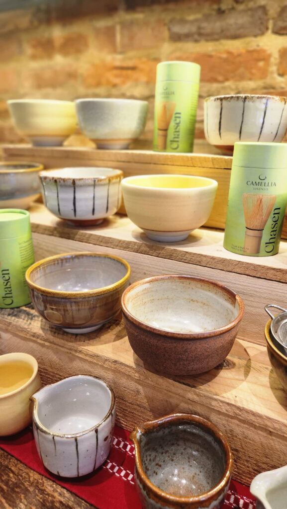 many matcha bowls on wooden shelf