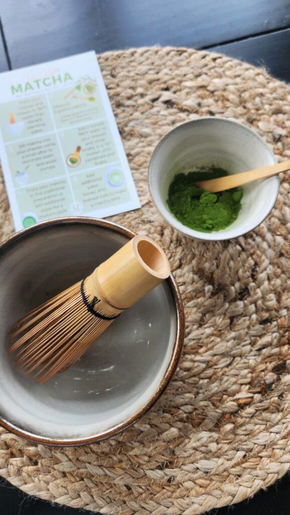 matcha bowl with chasen whisk and green matcha prior to making the drink