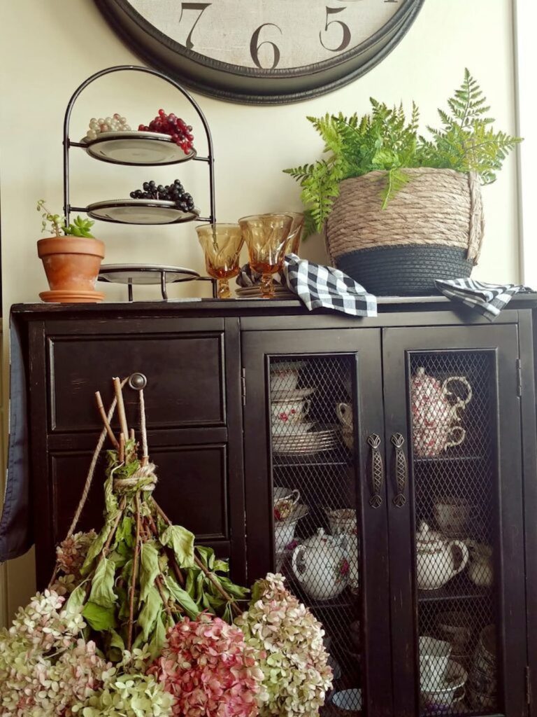 hydrangea hanging from black sideboard in kitchen