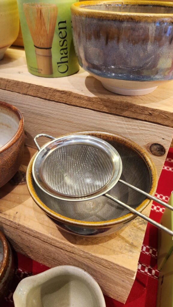 stainless steel strainer placed in a matcha bowl