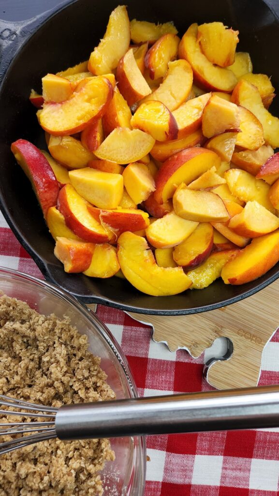 sliced peaches in cast iron skillet