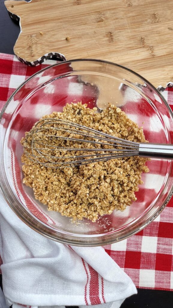 peach crumble in glass bowl ready to put on top of peaches