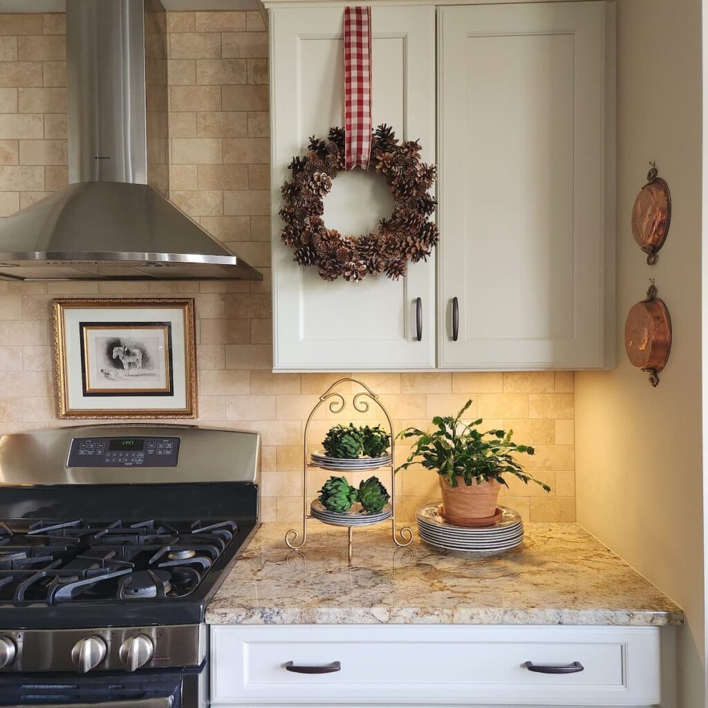 pine cone wreath hanging on kitchen cabinet