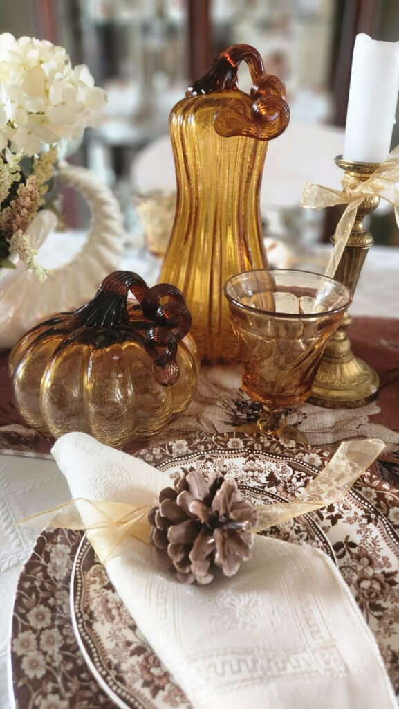 amber glass pumpkin on table with amber glass goblet