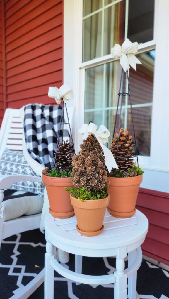 diy outdoor topiary with pinecones front porch table