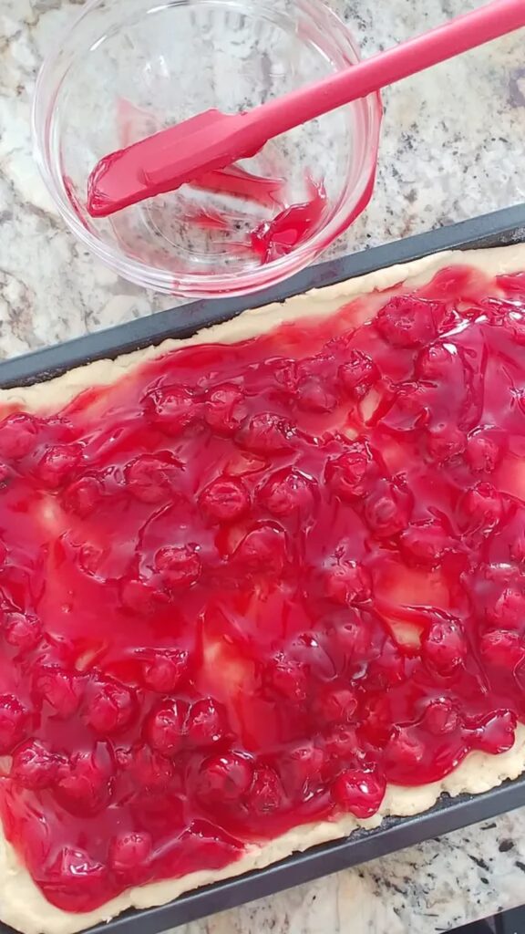 cherry tarts being made on counter