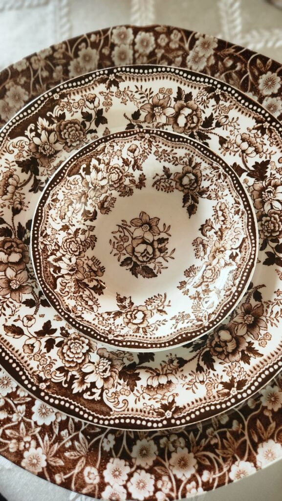 brown vintage chintz dishes with a soup bowl and fruit bowl stacked on top of placesetting