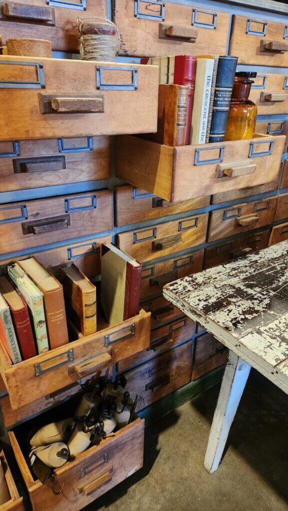 old wooden chest with drawers pulled out and books in them