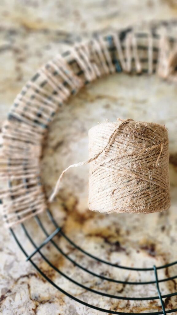 jute string wrapped around a wire form prepping for adding pine cones to the wreath