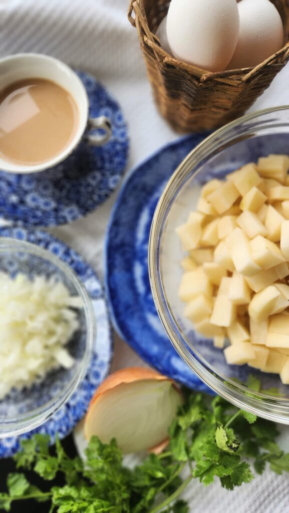 chopped and diced onion and potatoes in glass bowls