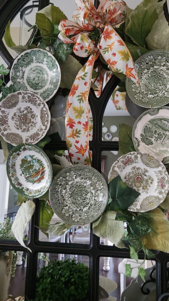 vintage plate wreath hanging on a mirror