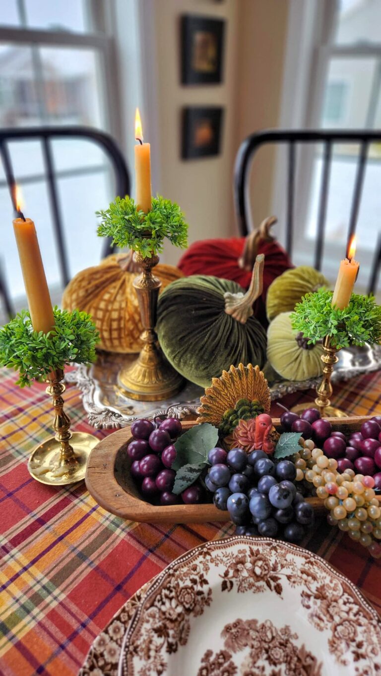 fall table with faux fruit and pumpkins