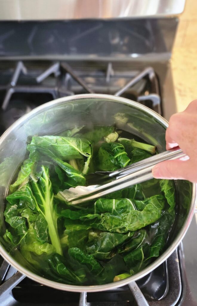 brussel sprout leaves in stock pot of hot water