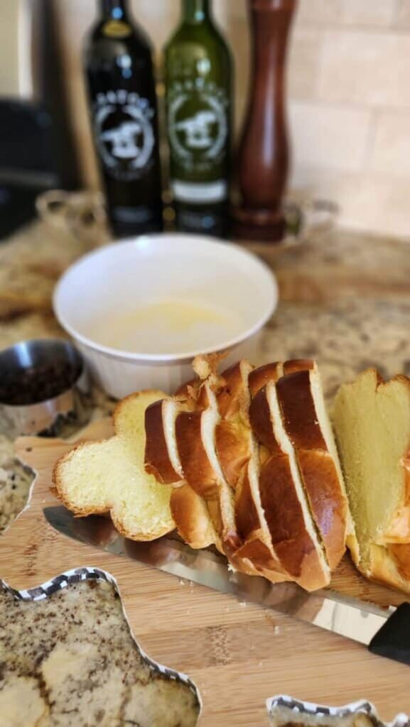 slices of fresh challah bread on cutting board