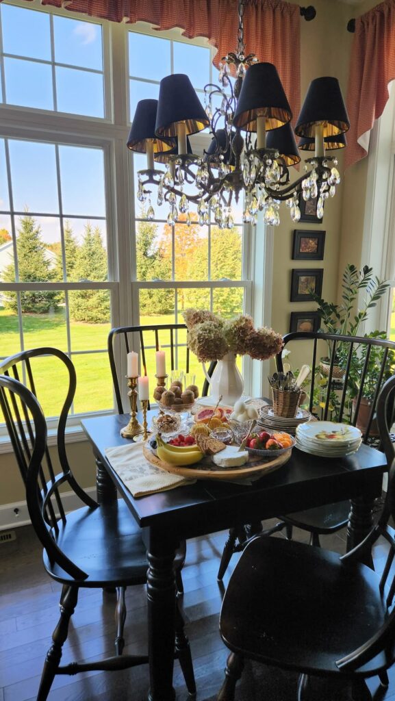 breakfast room table with small charcuterie board and simple hydrangea arrangement 