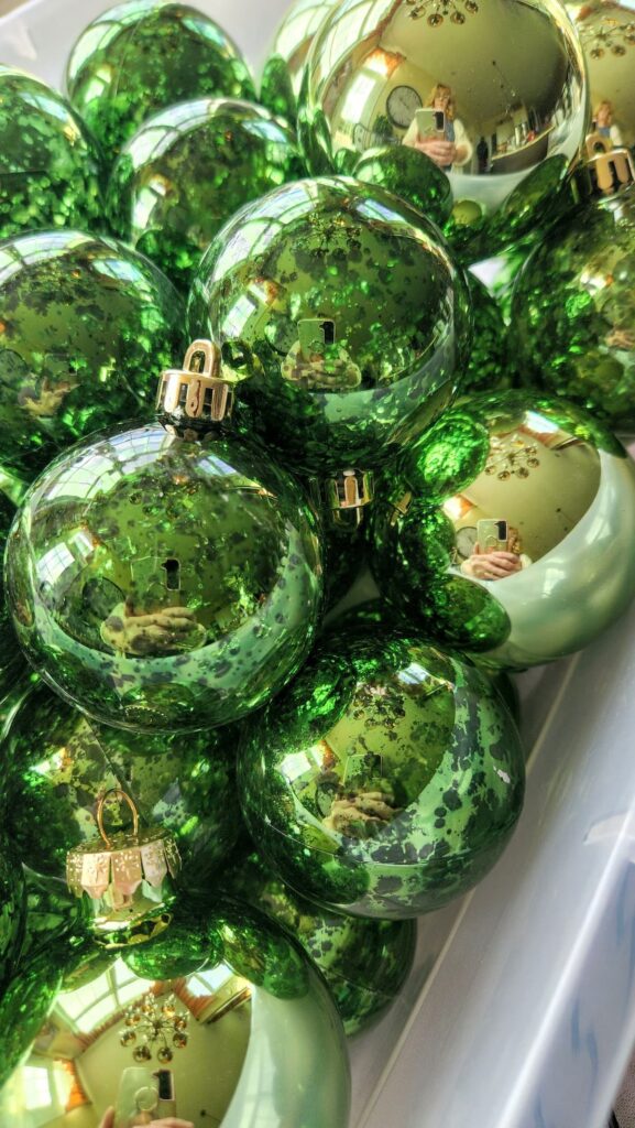 green ornaments in a bin 