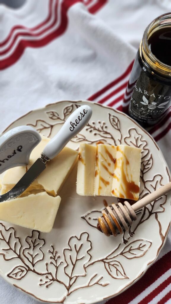 buckwheat honey drizzled on top of slices of sharp cheese