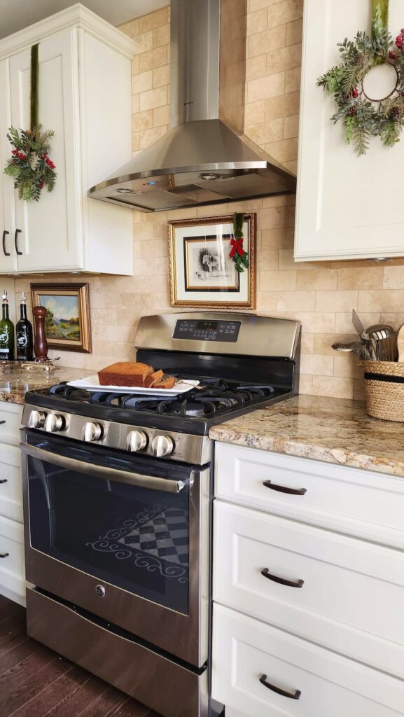 kitchen cabinets with christmas wreaths on them