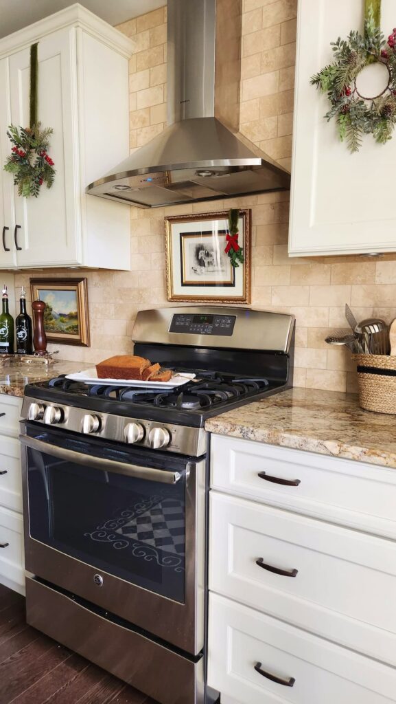 kitchen cabinets with christmas wreaths on them