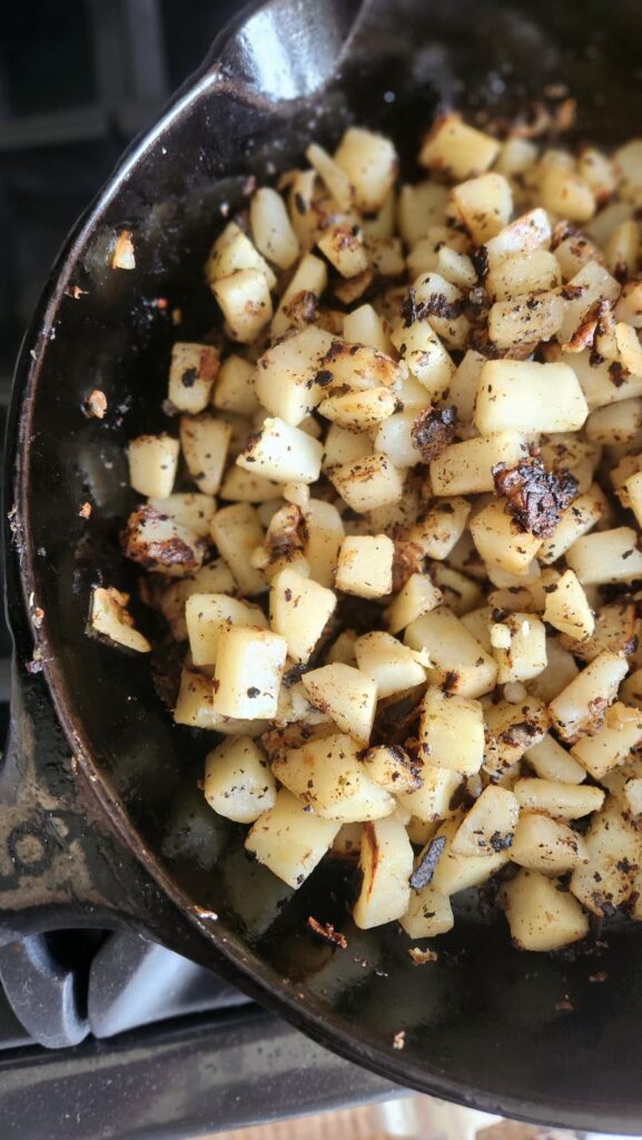 diced potatoes in cast iron skillet