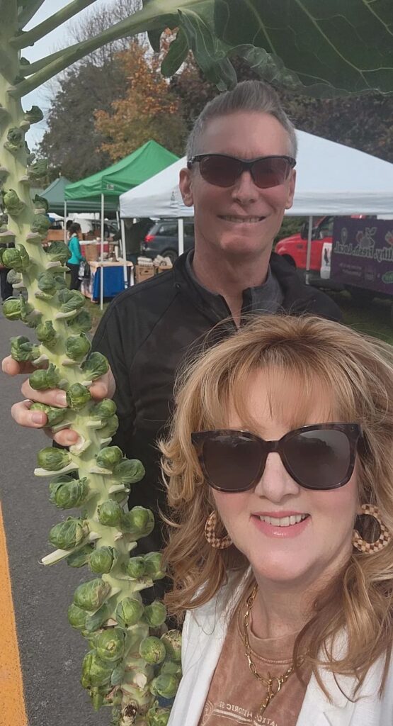 Andrew and I at farmers market buying brussel sprouts on large stem 