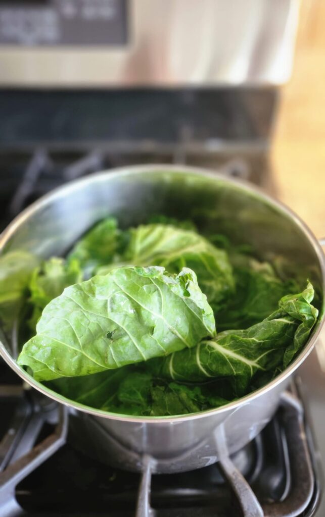 brussel sprout leaves in stock pot of boiling water