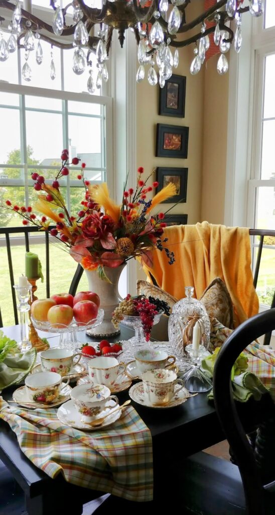 fall table with large autumn arrangement on top of it