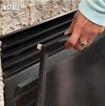 close up of a gas fireplace safety screen being put on fireplace