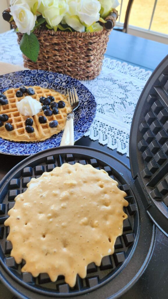 waffle iron with waffle dough poured on to it