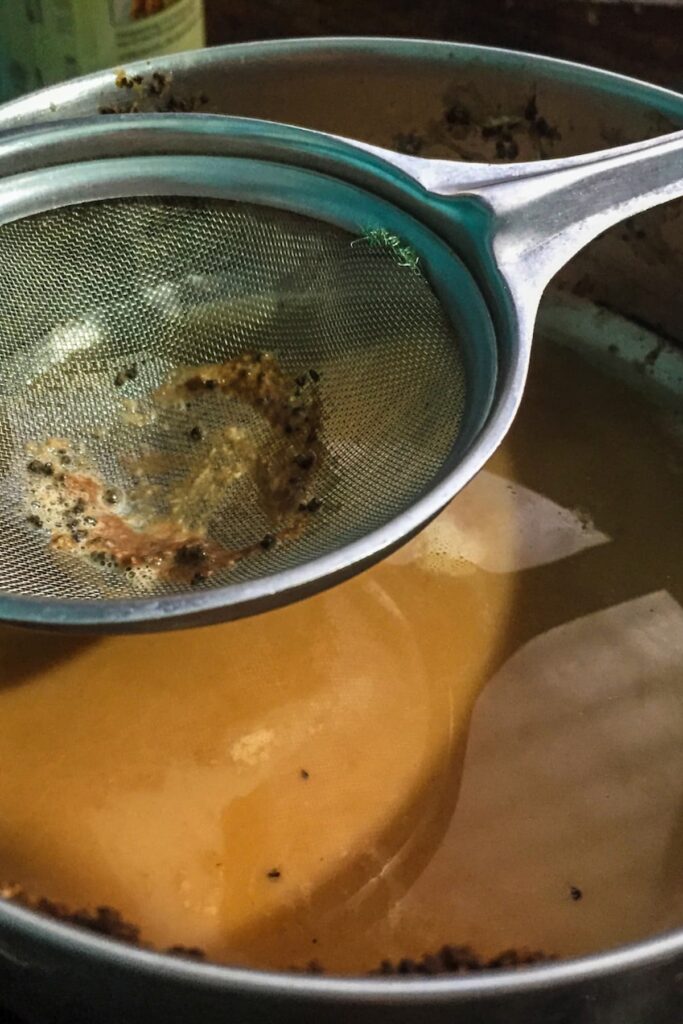 strainer with tea being strained for fertilizer