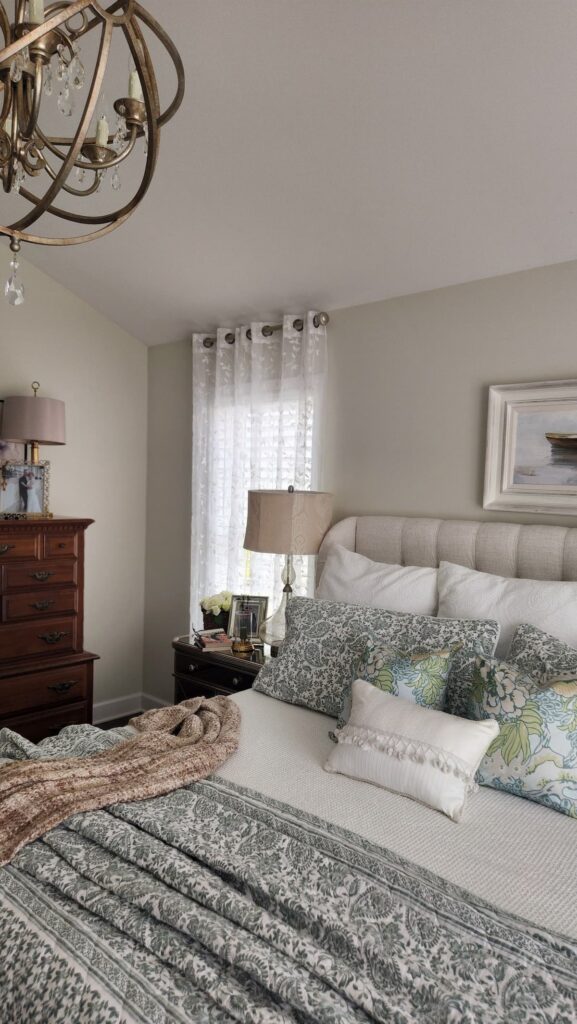 main bedroom with green chinoiserie bedding and upholstered bed 