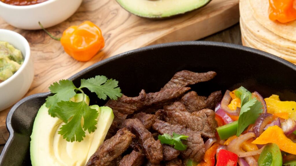 beef and vegetables in a cast iron skillet