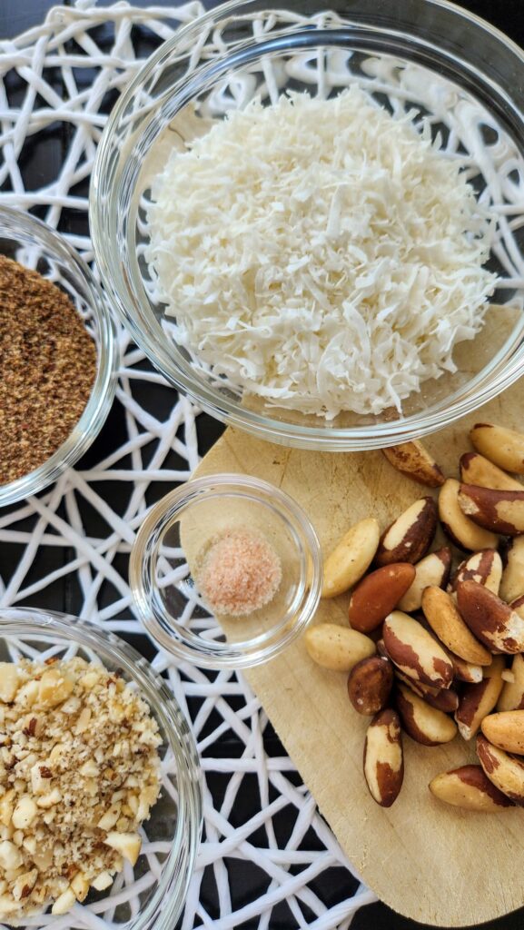 shredded coconut, flax seeds, brazil nuts on table ready for making flax seed bars